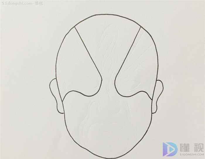 脸谱怎么画 脸谱简笔画教程(先画脸谱的基本轮廓,画出两个耳朵,面部画出眼睛、嘴巴等区域的)